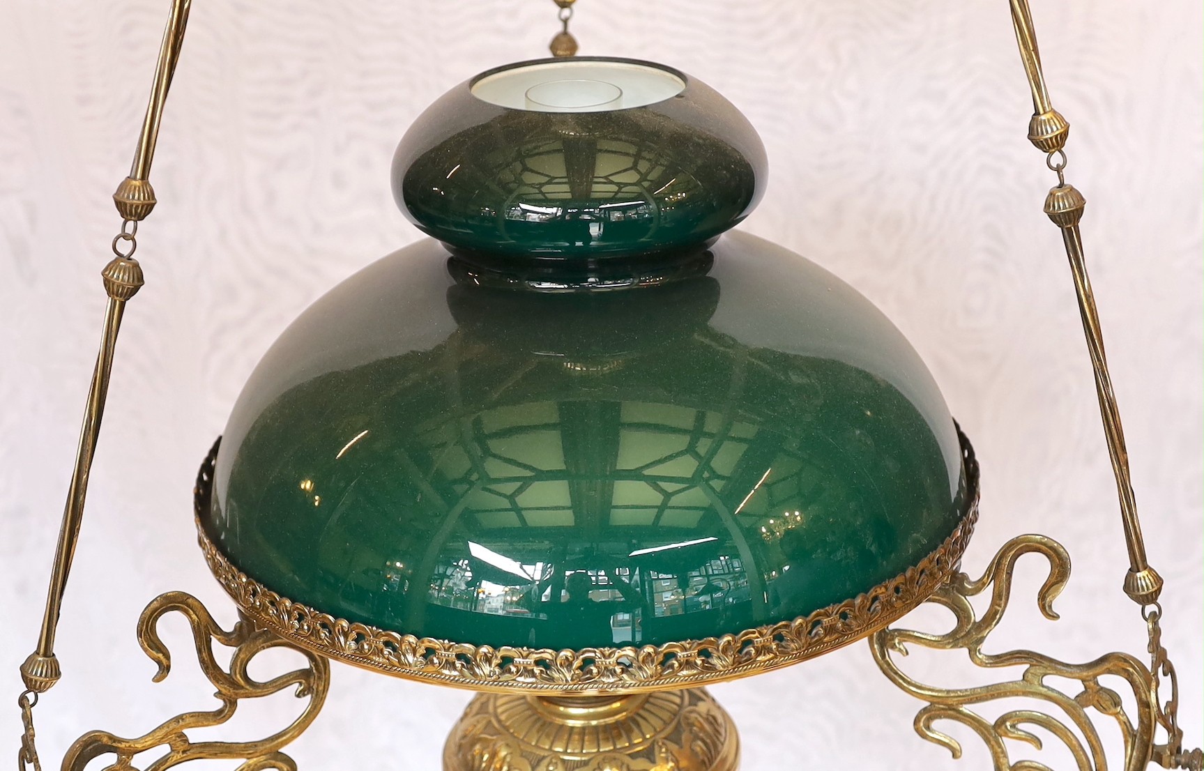 A 19th century French embossed brass counterbalanced hanging oil lamp with opaque glass shade, height 110cm. width 50cm